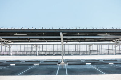 Empty parking lot against clear sky