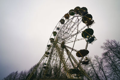 Low angle view of ferris wheel against sky