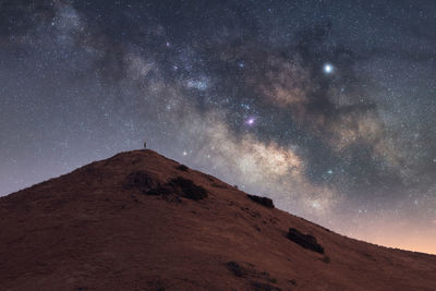 Low angle view of mountain against sky at night