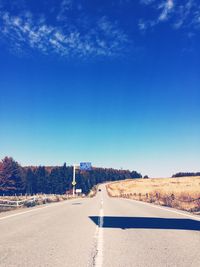 Scenic view of road against clear blue sky