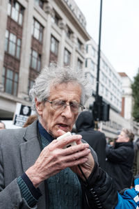 Portrait of man in city during winter