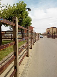 Empty road with buildings in background