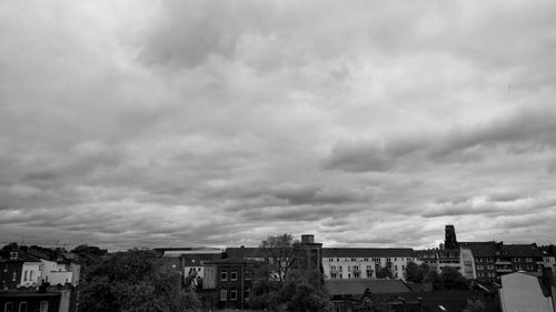 Houses in city against sky