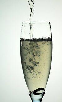 Close-up of drink in glass against white background