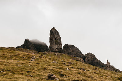 Rock formations on mountain against clear sky