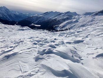 Scenic view of snow covered mountains against sky