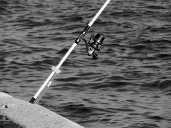 High angle view of fishing rod against river