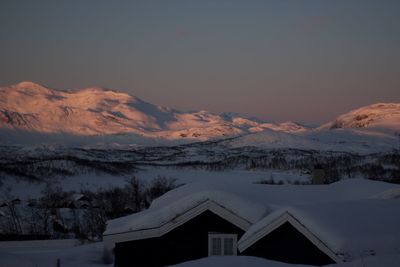 Scenic view of snowcapped mountains against sky during winter