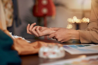 Midsection of woman using laptop on table