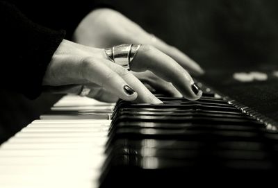 Close-up of man playing piano