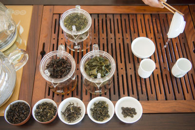 High angle view of various tea leaves in bowls on table