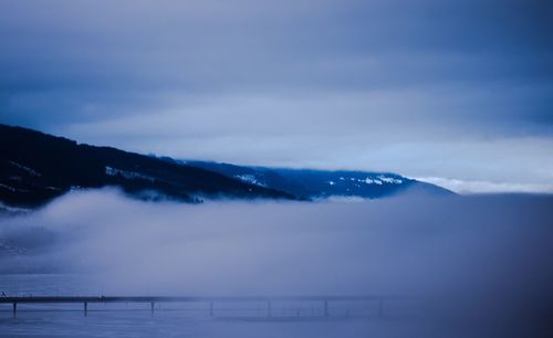 Scenic view of mountains against cloudy sky