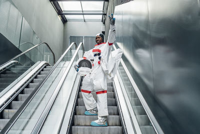 Low angle view of people walking on escalator