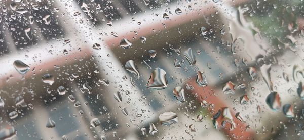 Full frame shot of wet glass window in rainy season