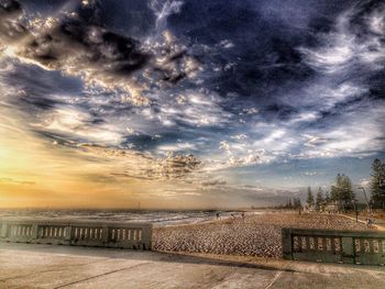 Scenic view of field against cloudy sky