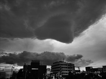 Buildings against cloudy sky