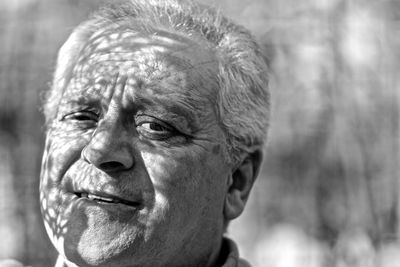 Close-up portrait of man looking away outdoors