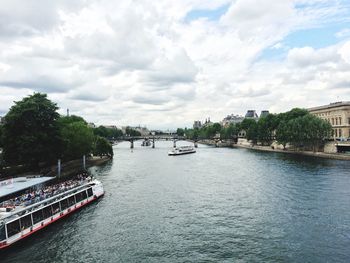 Boats in river with city in background