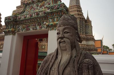 Statue of temple against building