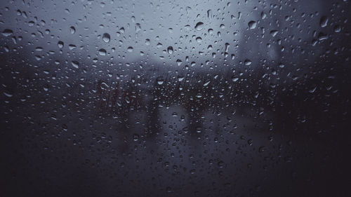 Full frame shot of raindrops on glass window