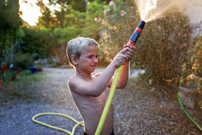 Side view of boy playing in park