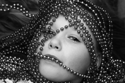 Close-up portrait of girl with beads