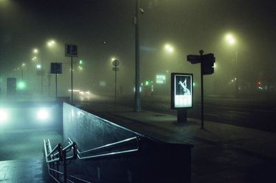 Low angle view of illuminated light near underpass at night 