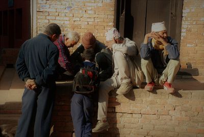 Men sitting on floor