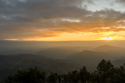 Scenic view of mountains against sky at sunset