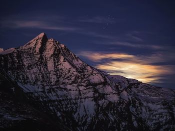 Scenic view of snowcapped mountains against sky during sunset