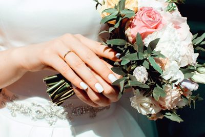 Midsection of woman holding bouquet