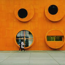 People on wall of building