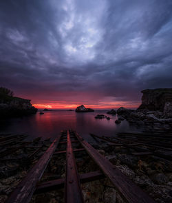 Reflection of clouds in sea at sunset