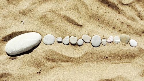 Stones arranged on sand at beach