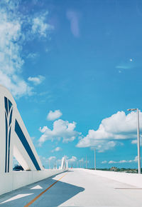Airplane on airport runway against sky