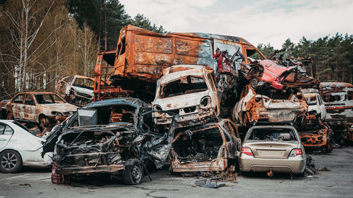 View of scrapped cars against sky