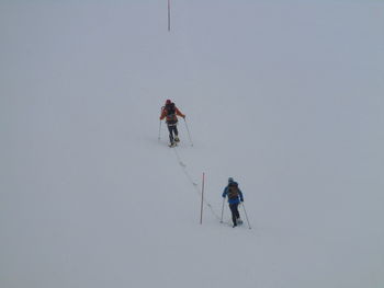 People skiing on snow covered mountain