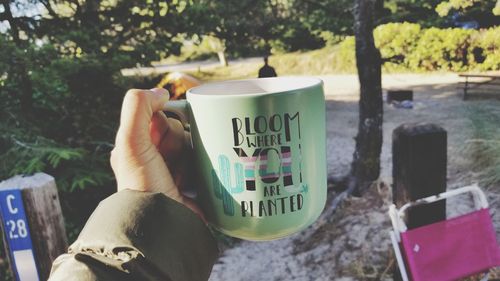 Midsection of person holding coffee cup