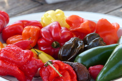 Close-up of various bell peppers in plate on table