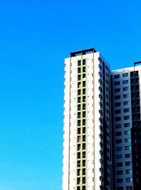 Low angle view of buildings against blue sky