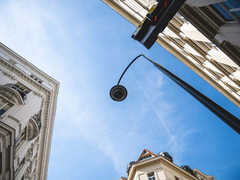 Low angle view of street light against buildings