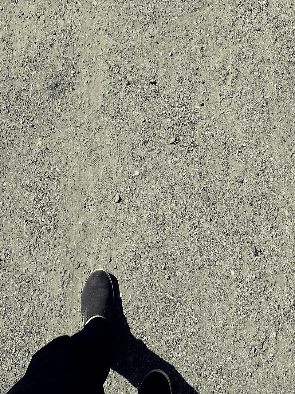 low section, person, personal perspective, shoe, human foot, standing, high angle view, footwear, lifestyles, unrecognizable person, men, part of, leisure activity, street, directly above, shadow, day