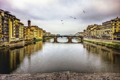 View of bridge over river against cloudy sky