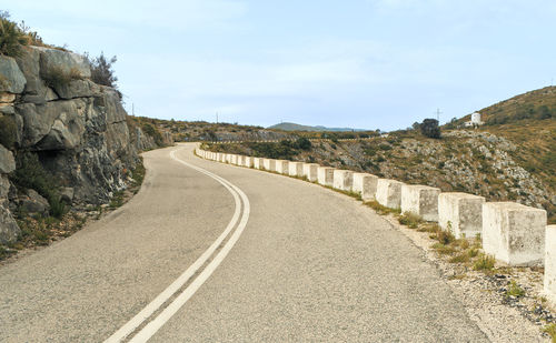 Mountain road with curves and rocks to protect against exits.