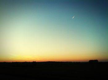 Scenic view of silhouette landscape against clear sky during sunset