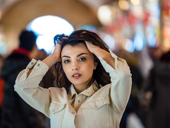 Portrait of woman with hand in hair