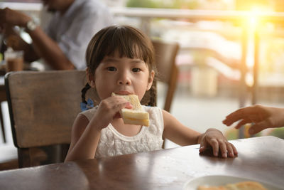 Portrait of cute girl eating food