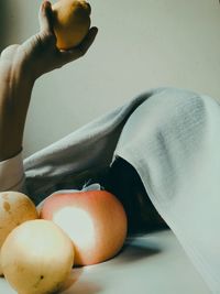 Close-up of man holding apple