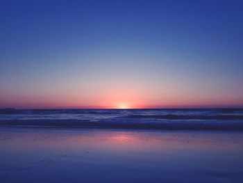 Scenic view of sea against clear sky at sunset