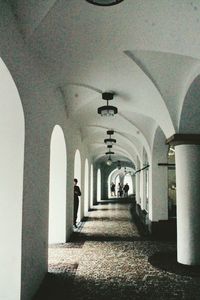 Rear view of woman walking in corridor